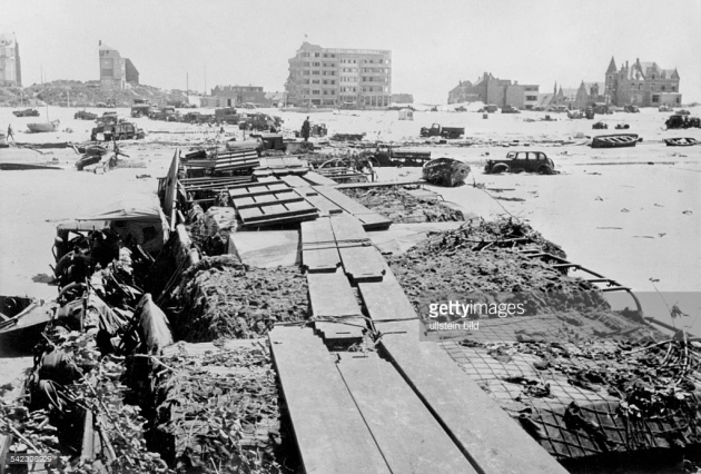 Bridge constructed of British army lorries topped with decking, La Panne, 1940.